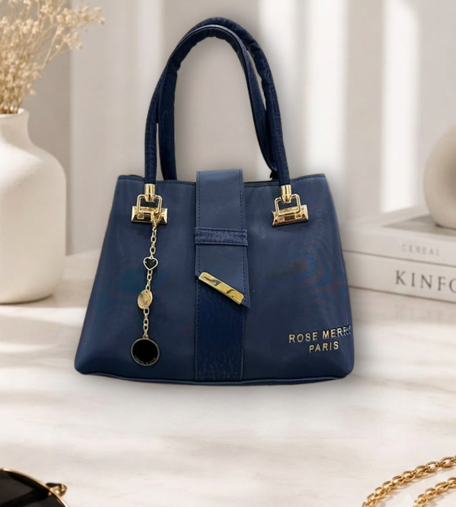 Navy blue structured handbag with gold hardware and a hanging charm